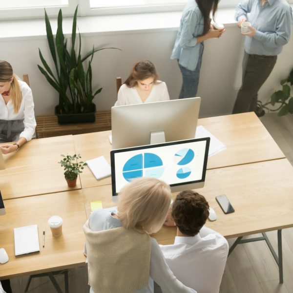 Senior and young employees work in office together, older executives training colleagues, corporate staff discussing ideas collaborating in coworking, team people group teamwork, top vertical view